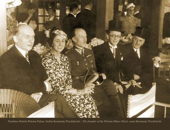 An old black & white photo of five guests sitting in elegant attire at Polonia Palace Hotel