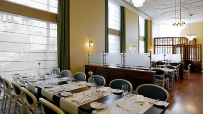 Polonia Restaurant with set tables, wooden floors, and large windows at Polonia Palace Hotel