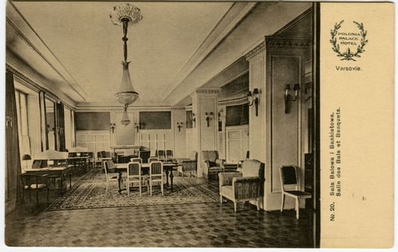 Old vintage photo of an elegant interior with chairs, tables, and a chandelier at Polonia Palace Hotel