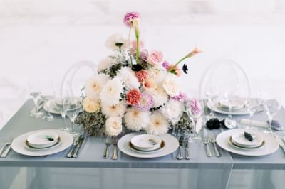 Table set up with floral decor and fine dinnerware at Polonia Palace Hotel